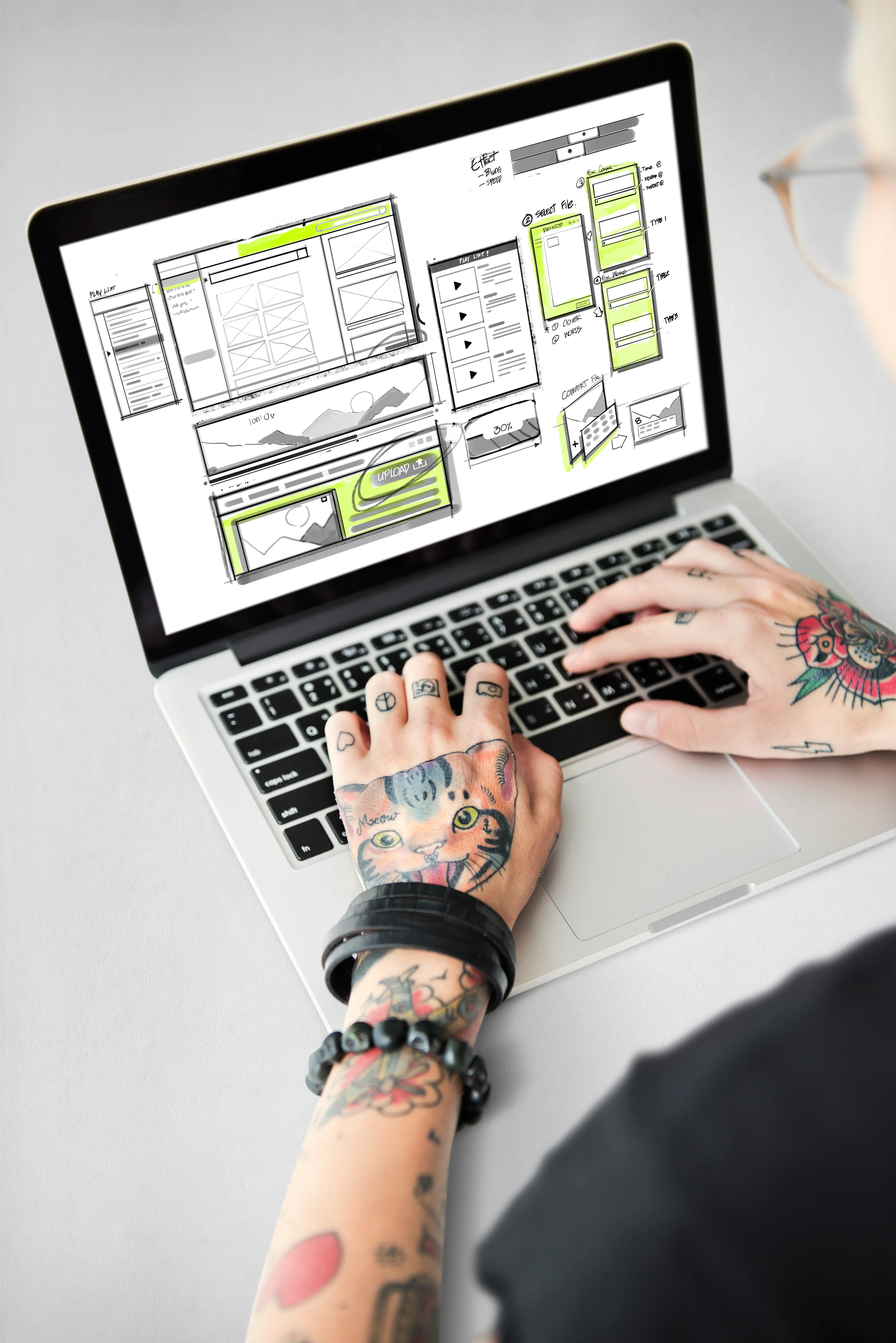 A designer laying out a small-business website on a laptop