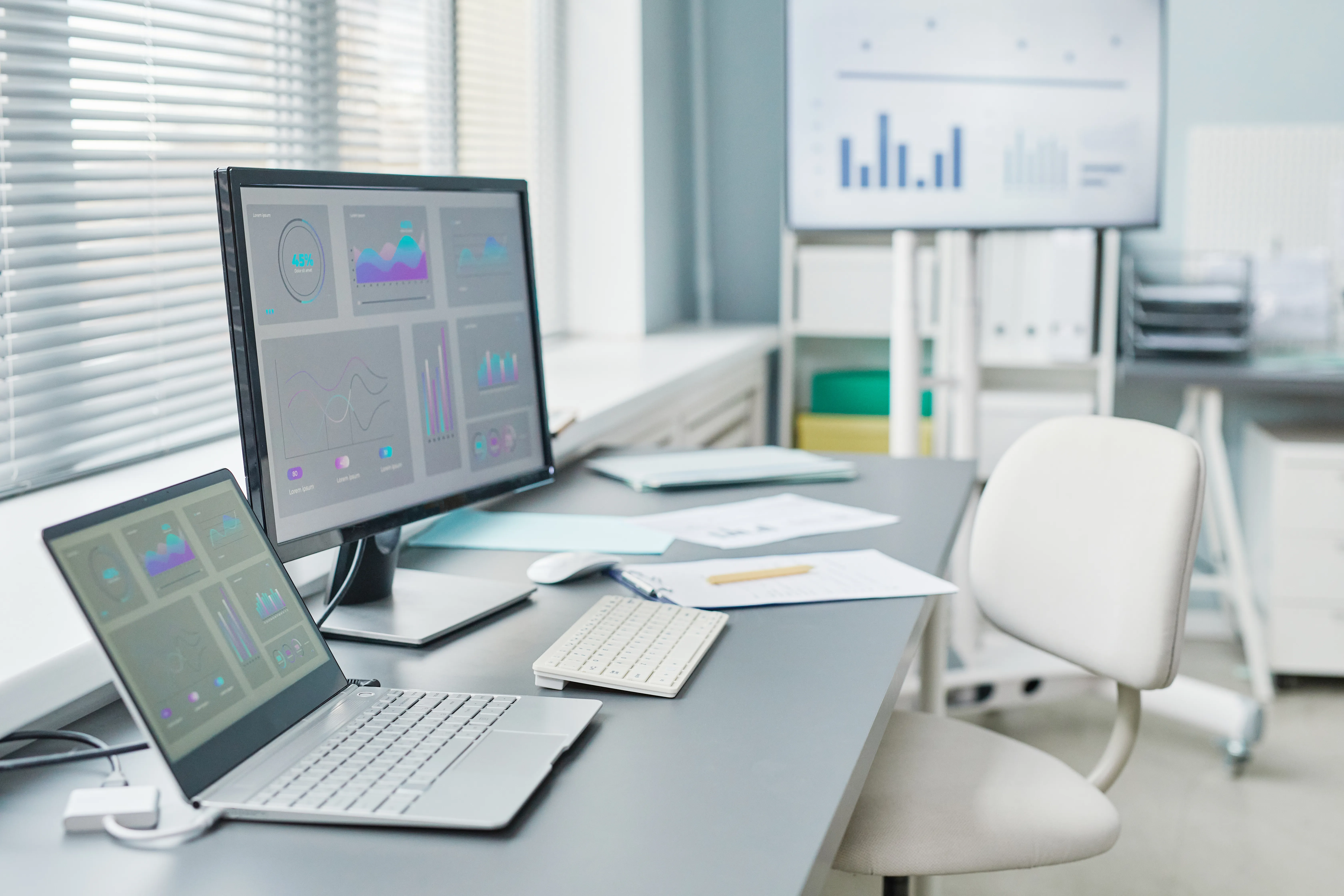 A tidy workspace with a monitor and laptop